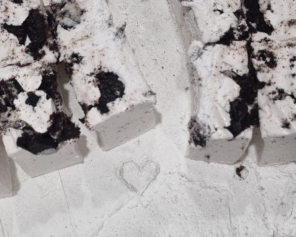 soft fluffy marshmallows with love heart in icing sugar